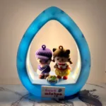 Best Wishes Gift for Couple featuring cute boy and girl figurines in a glowing blue frame.