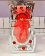 Decorative curved glass vase showpiece with ribbon and floral design