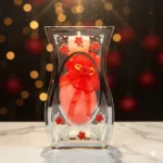 Decorative curved glass vase showpiece with ribbon and floral design