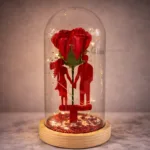 Red artificial rose inside glass dome with warm LED lights and wooden base