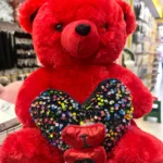 Red soft teddy bear with heart romantic gift for couples