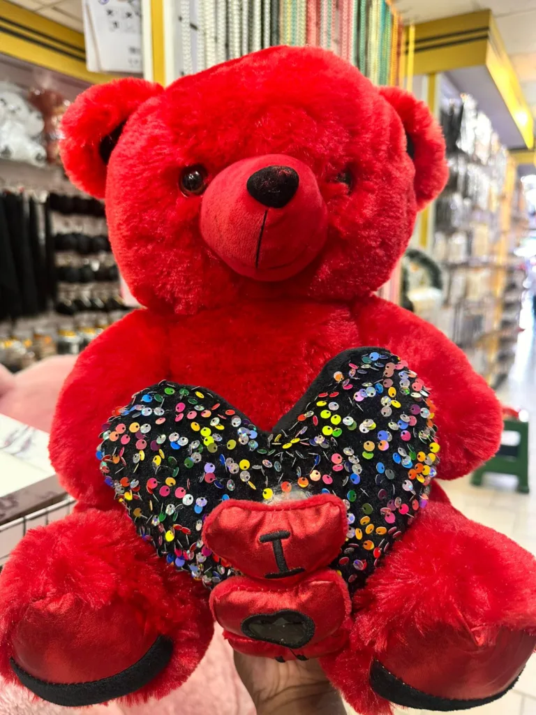 Red soft teddy bear with heart romantic gift for couples